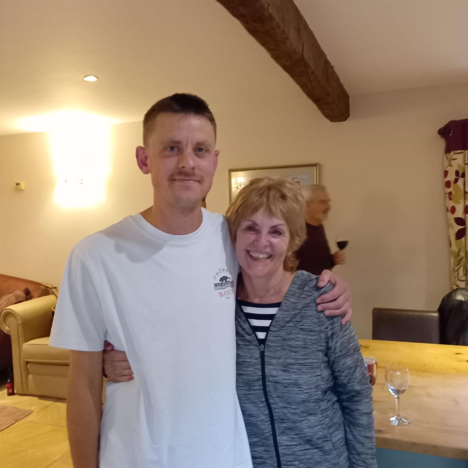 Chris with his mum, Celestina, arm in arm at home