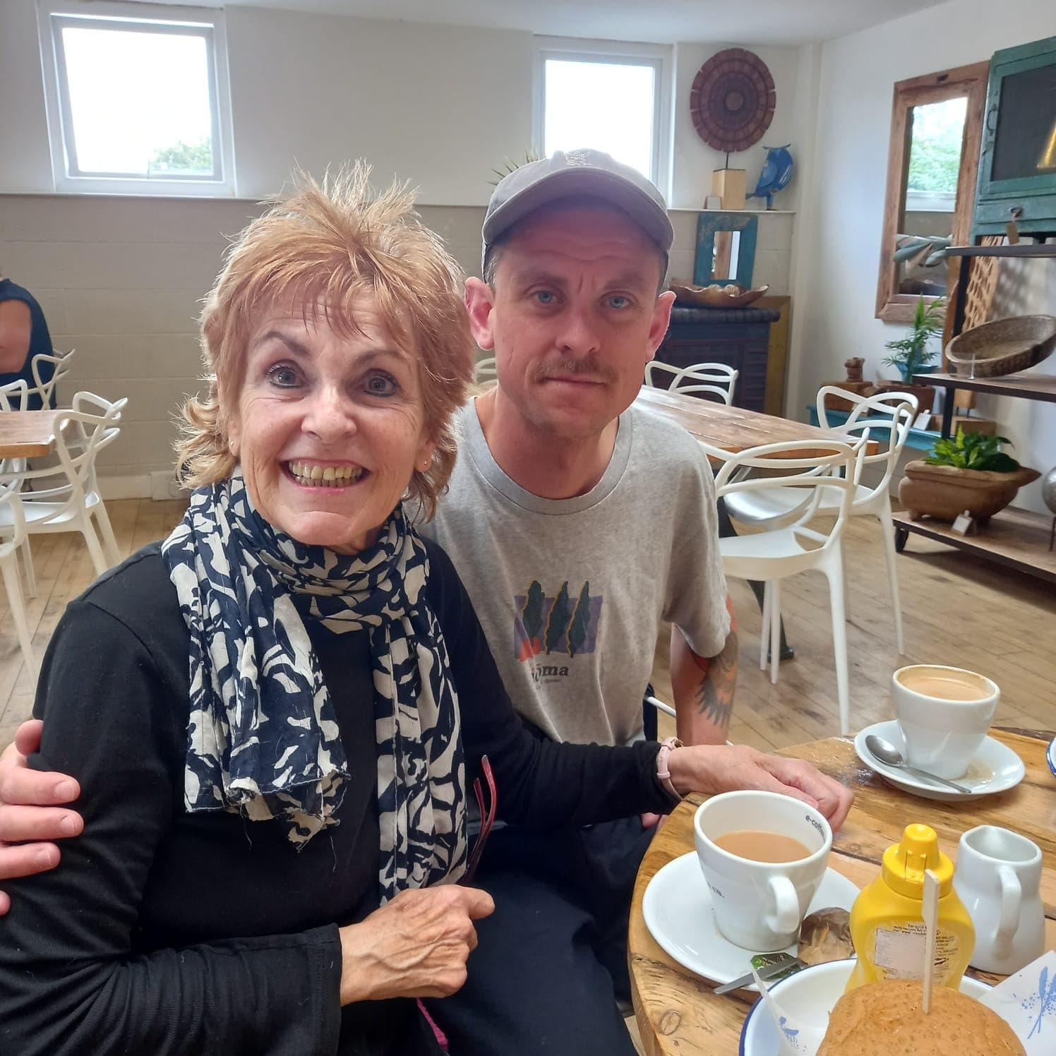 Chris with his mum, Celestina, smiling over coffee