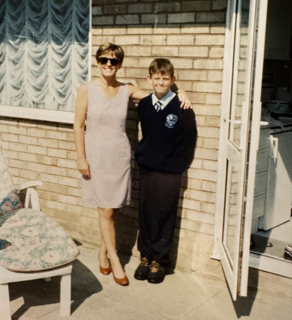 Chris as a boy in his school uniform, with his mum, Celestina, her arm round his shoulder